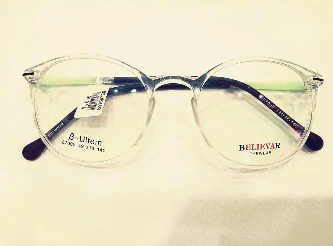 Transparent round acetate frame with green temples
