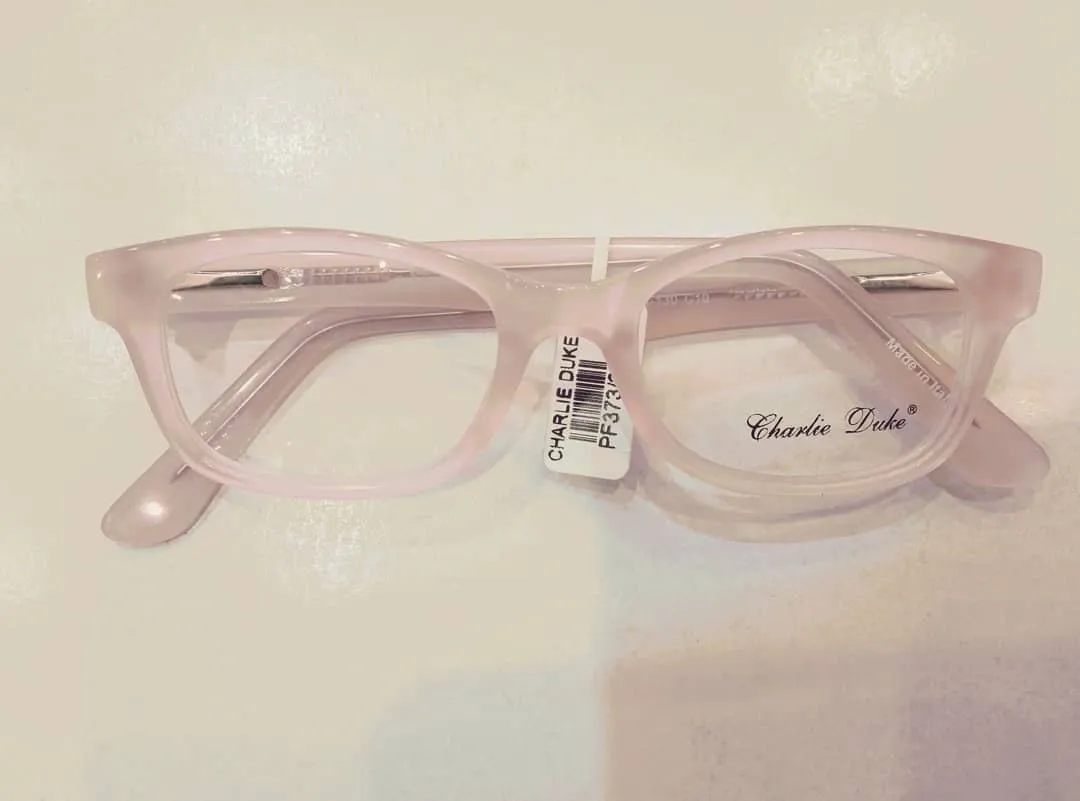 Soft pink kids glasses on a light counter