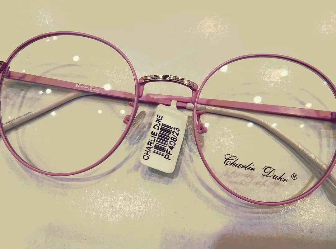 Pink round metal frame on a cream counter